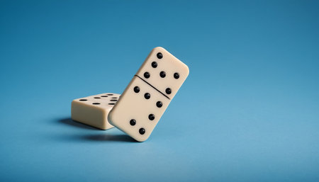 Two dominoes on a blue background. Domino effect.の素材