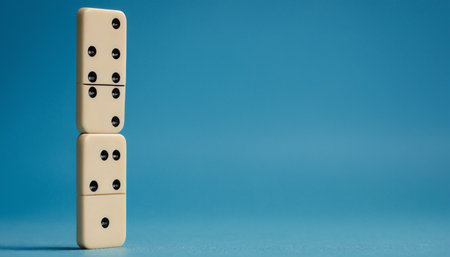 Dominoes on a blue background. Domino effect concept.の素材