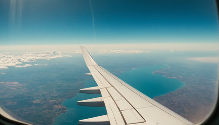 View from the airplane window on the wing of the plane in the skyの素材