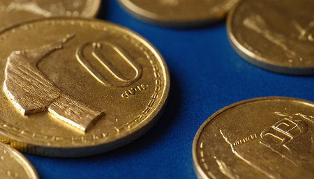 Close up of gold euro coins on blue background. Financial concept.の素材