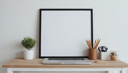 Modern workplace with blank screen laptop, stationery and coffee cup on wooden tableの素材
