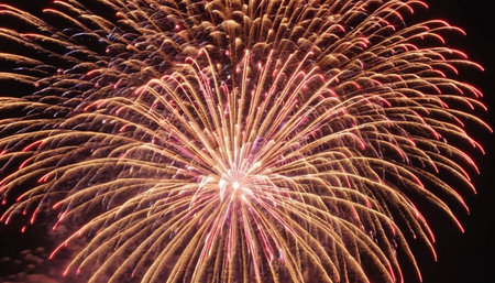 Colorful fireworks of various colors over night sky background. Selective focus.の素材