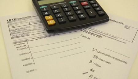 Calculator and tax form on the table. Close up.の素材