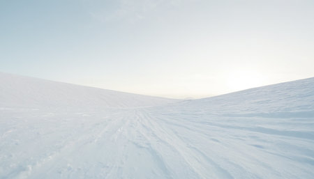 Beautiful winter landscape with snowdrifts and blue sky at sunsetの素材
