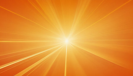 sunbeams on a soft orange background with lens flare and copy spaceの素材