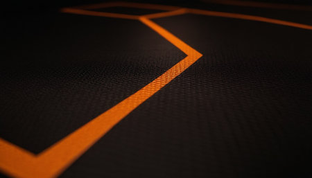 A closeup shot of an orange line on a black flooringの素材