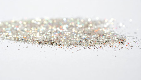 Silver glitter confetti on white background. Shallow dof.の素材