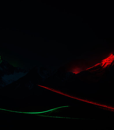Mountain road with red and green lights at night. Abstract backgroundの素材