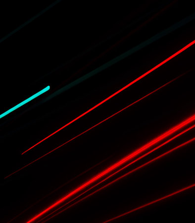 abstract background with red and blue light lines on black background.の素材