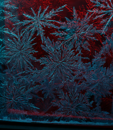 Frosty natural pattern on the window glass. Beautiful winter backgroundの素材