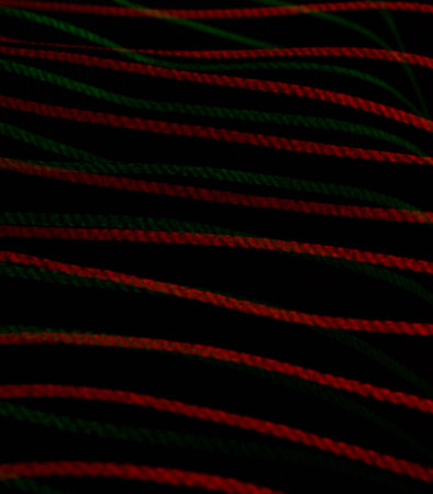Red and green lines on a black background. Abstract background for design.の素材