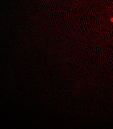 Abstract red halftone dots on black background. Vector illustration.の素材