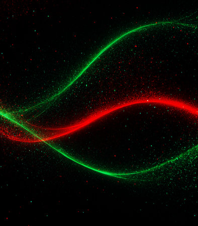 abstract background with red, green, blue and green glowing particlesの素材