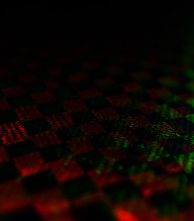 Abstract background with red and green checkered pattern on black backgroundの素材