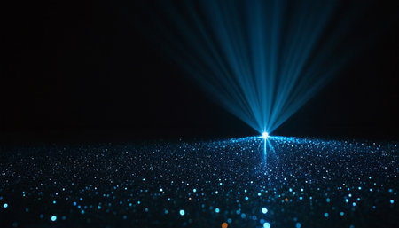 Glittering particles on black background. Glittering particles.の素材