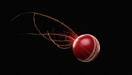 Cricket ball with flying trail of fire on a black backgroundの素材