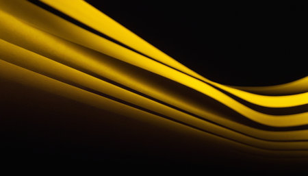 Abstract background of yellow curved lines on a black background. Close-up.の素材