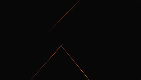 abstract background with a glowing orange triangle in the center and a black backgroundの素材