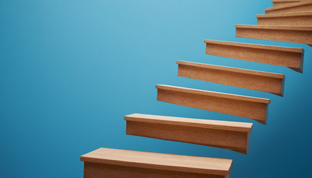 Wooden stairs on a blue background. Business and finance concept.の素材