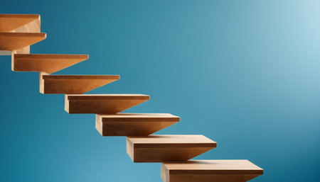 Wooden stairs on blue background. Business success and growth concept.の素材