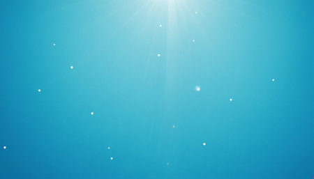 Abstract blue sky background with sunbeams and lens flare effect.の素材