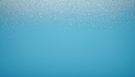 Falling snowflakes on blue background with copy space. Winter backgroundの素材