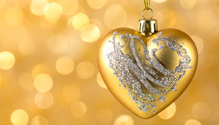 Christmas decoration with golden heart on bokeh background, closeupの素材