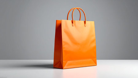 Orange shopping bag on gray background. 3D rendering. Mock up.の素材