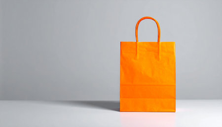 Orange paper bag on white background with copy space. 3d renderingの素材