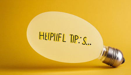 Lightbulb with text HAPPY TIPS on yellow backgroundの素材