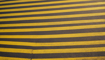 Yellow and black zebra crossing on the road. Abstract background.の素材