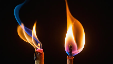 Burning match on a black background. Close-up image.の素材
