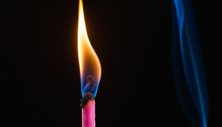 Burning candle on a black background, close-up, macroの素材
