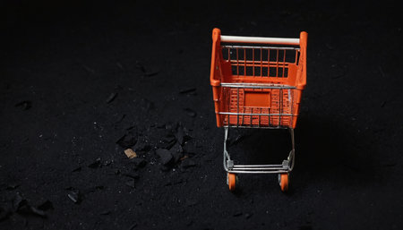 Shopping cart on a black background. Shallow depth of field.の素材