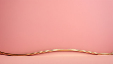 Curved golden wire on pink background. Copy space for your text.の素材