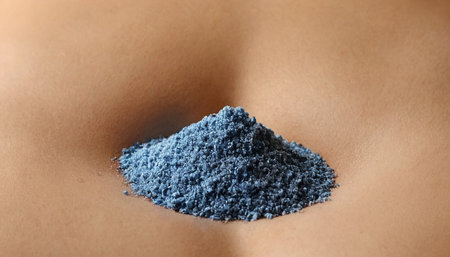 Close up of blue powder on woman's breast. Beauty treatment conceptの素材