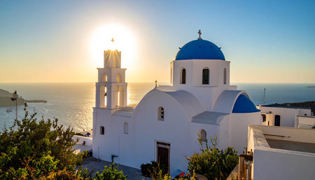 Image of white church on the greek island of santorini at sunsetの素材