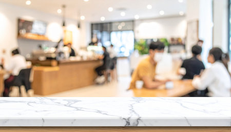 Empty white marble table top and blur coffee shop cafe and restaurant backgroundの素材