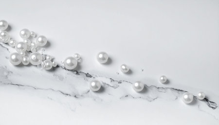 White pearls on a marble background. Flat lay, top view.の素材