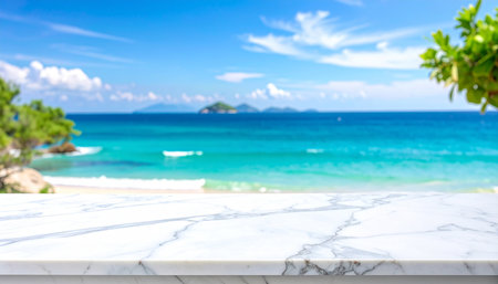 White marble table top with blur tropical beach background - can be used for display or montage your productsの素材