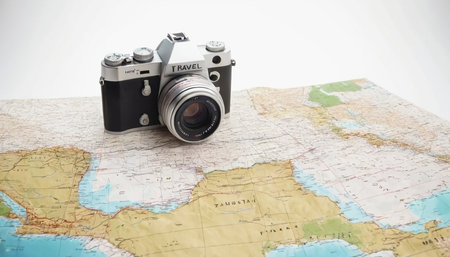 Vintage camera on a map of the world. Travel and tourism conceptの素材