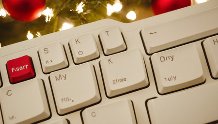 Computer keyboard with christmas tree on background, close-up viewの素材