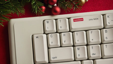 White computer keyboard with christmas decoration on red background, closeupの素材