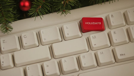 Computer keyboard with christmas tree and red button. Selective focus.の素材