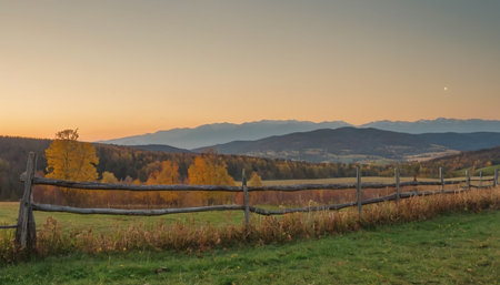 Beautiful autumn landscape with colorful forest and mountains in the background.の素材