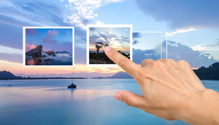 Hand pointing to the sky and sea photo collage on blue sky backgroundの素材