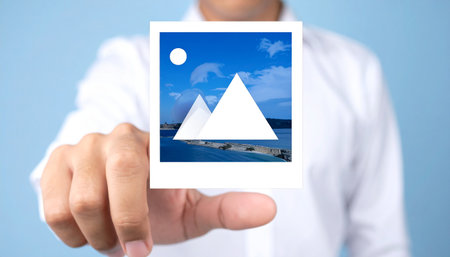 businessman holding a photo of pyramids in front of his bodyの素材