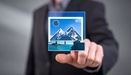 Man touching a digital photo concept on a touch screen with his fingersの素材