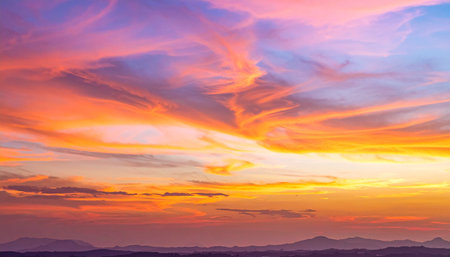 Beautiful colorful sky at sunset with cloud and mountain in the backgroundの素材