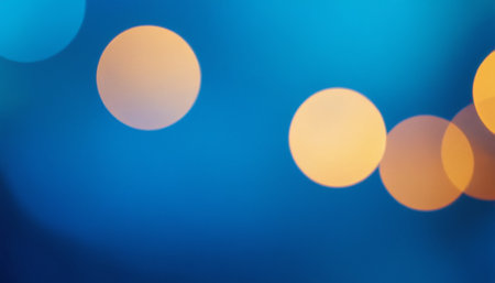 Abstract circular colorful bokeh from the party light on blue backgroundの素材